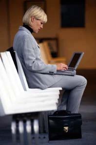 woman in slack suit working on a laptop